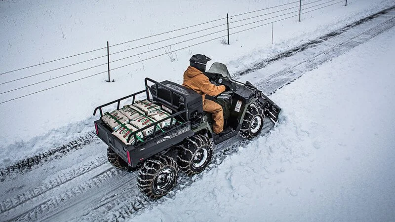 6x6 UTV driving on snow covered street