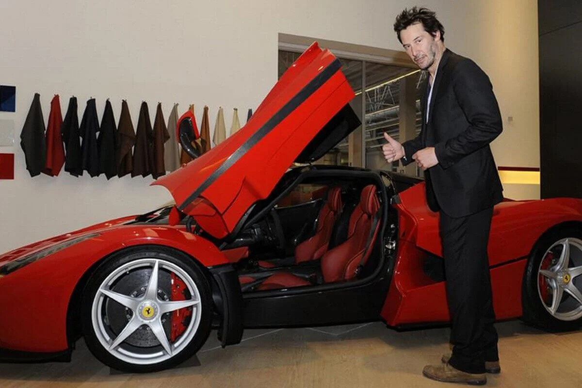 Keanu Reeves in front of Ferrari