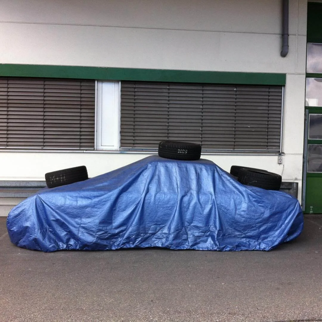 hidden car under tarp with tires