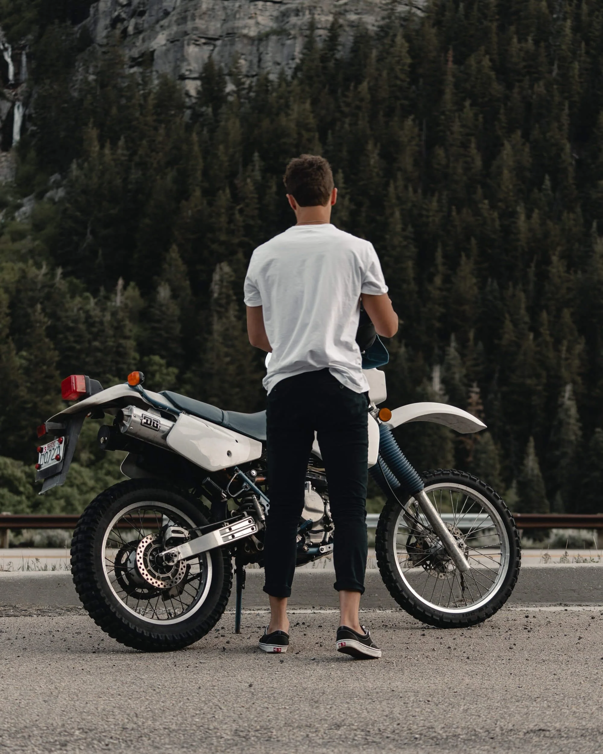 man standing beside electric dirt bike