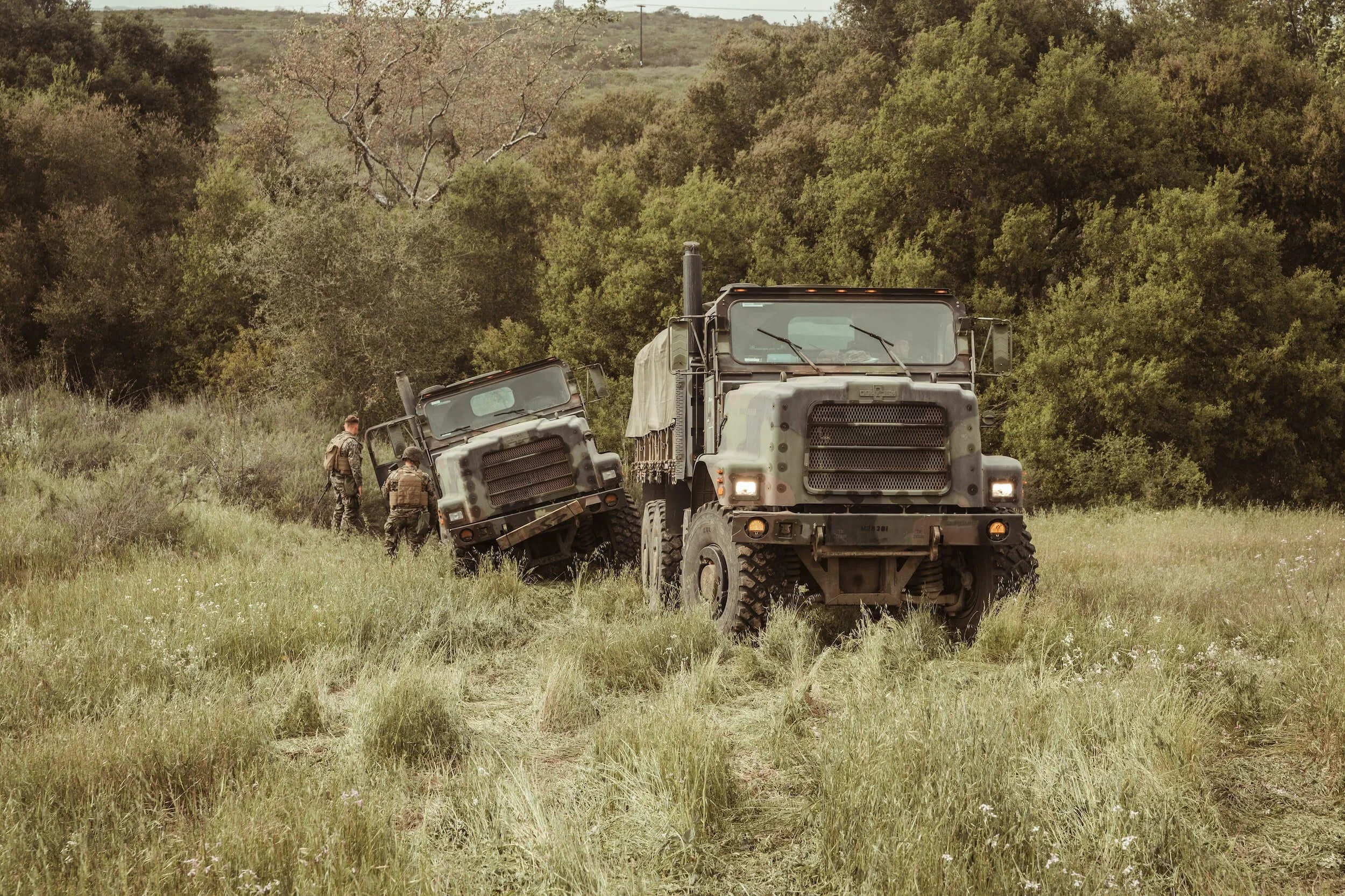 military vehicles on grass covered field