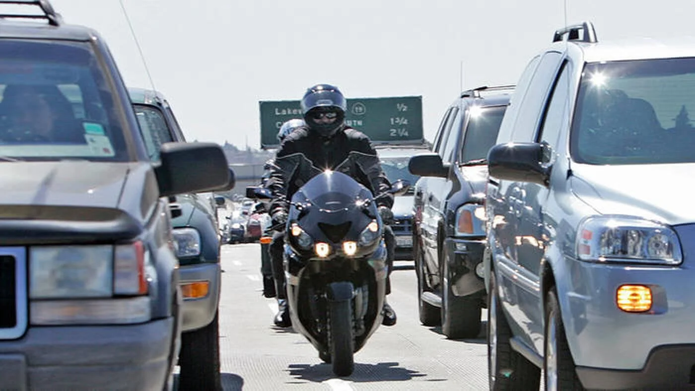 motorcycle rider going through traffic
