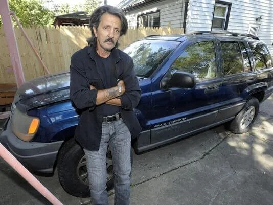 upset guy in front of car
