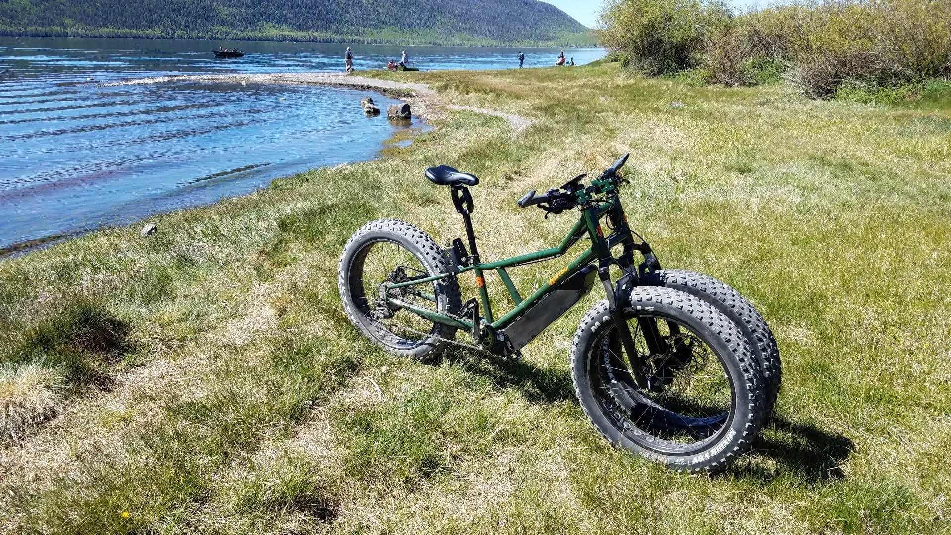 rungu electric dirt bike on grass field beside river