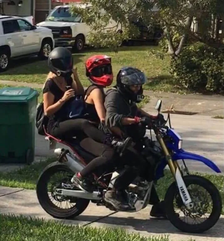 2 girls and a guy on dirt bike