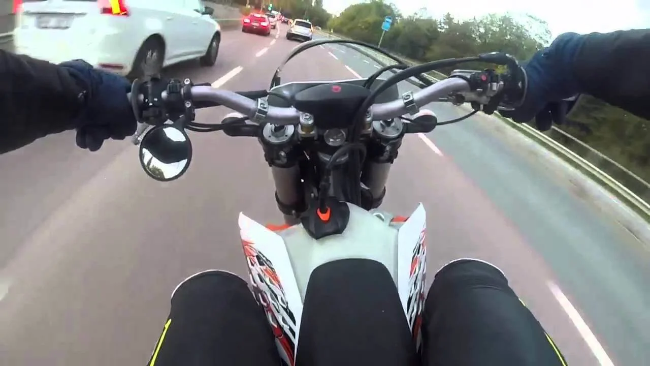 dirt bike rider on street traffic