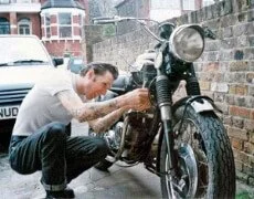 man checking motorcycle