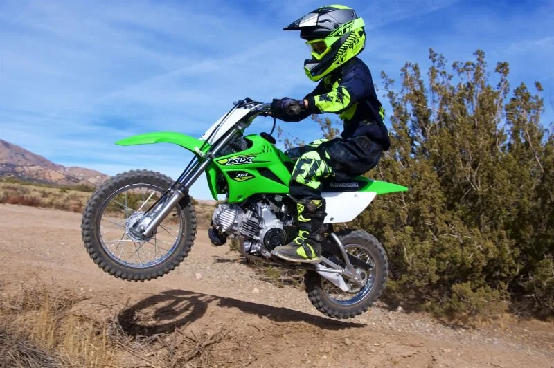 kawasaki dirt bike jumping in the air
