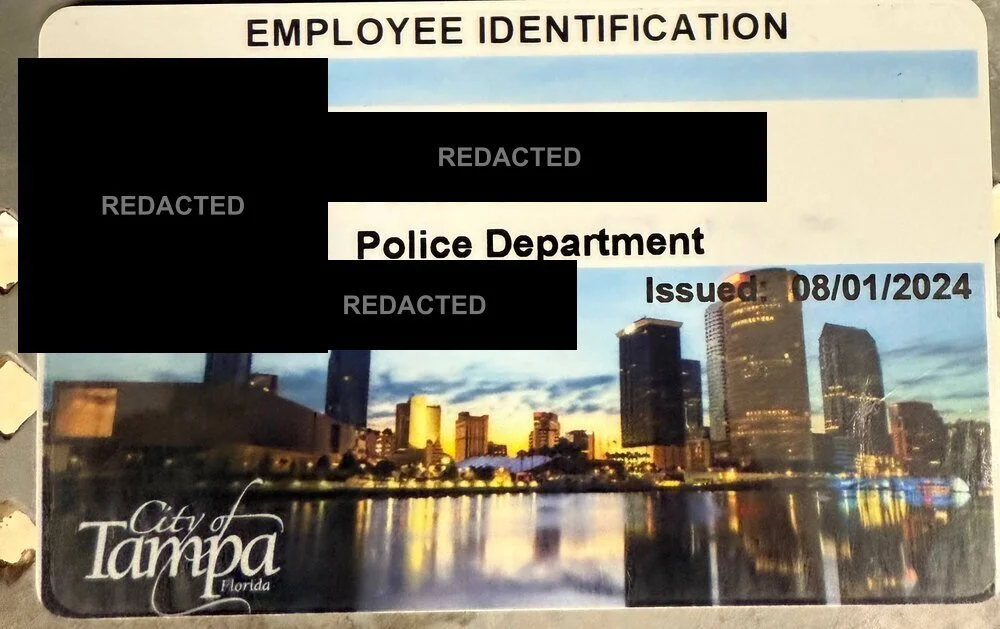 A government-issued officer photo ID showing the officer's photograph, name and department