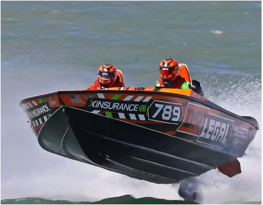 Dirt Legal Velocity #789 airborne off a wave with two crew in orange helmets during the Clearwater Offshore Nationals